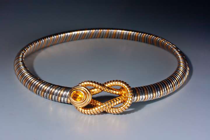 An 18 karat gold and stainless steel necklace
